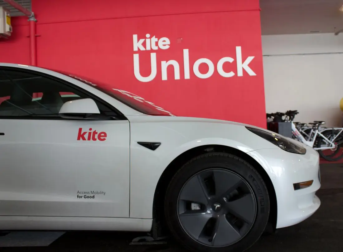 A Kite car parked at the Birch House hub by the Kite Unlock wall