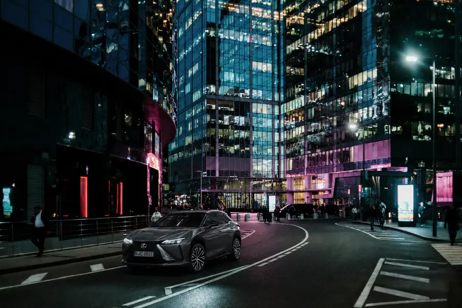 The Lexus RZ 450e on a quiet city street at night